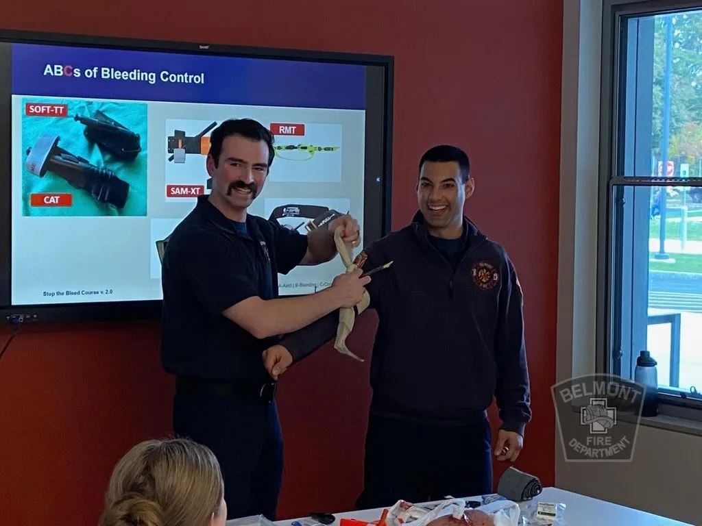 Firefighter Presents a Tourniquet Option on the Arm of Another Firefighter